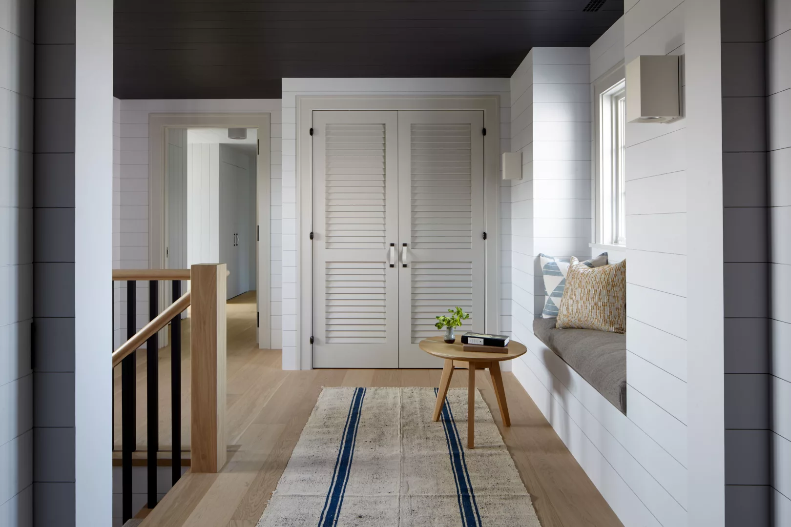 Hallway with painted paneling and a dark gray ceiling